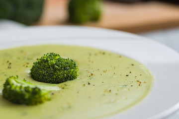 Broccoli soup in white bowl