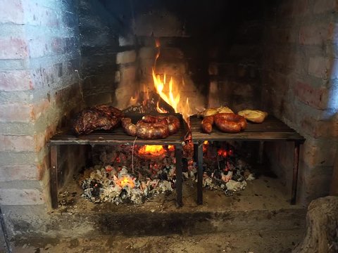 Roasting meat, sausage and chicken on a grill. Traditional Asado in Argentina