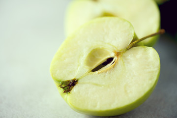 Organic green vegetables and fruits on grey background. Copy space. Green apple, lettuce, cucumber, avocado, kale, lime, kiwi, grapes, banana, broccoli