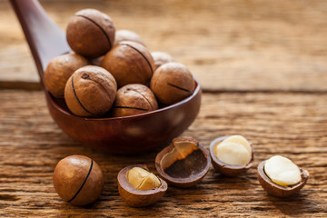 Close up macadamia nuts on wooden plate