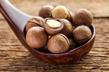 Close up macadamia nuts on wooden plate