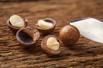 Close up macadamia nuts on wooden plate