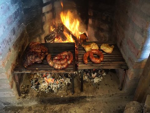 Roasting meat, sausage and chicken on a grill. Traditional Asado in Argentina