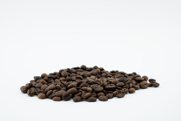 Roasted coffee beans on white background.
