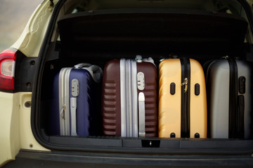 Opened car trunk full of suitcases, luggage, baggage. Summer holidays, travel, trip, adventure concept.