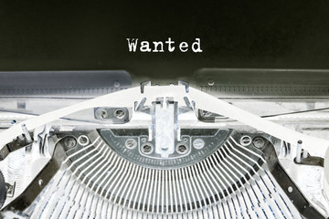 Wanted printed on a sheet of paper on a vintage typewriter. writer, journalist.