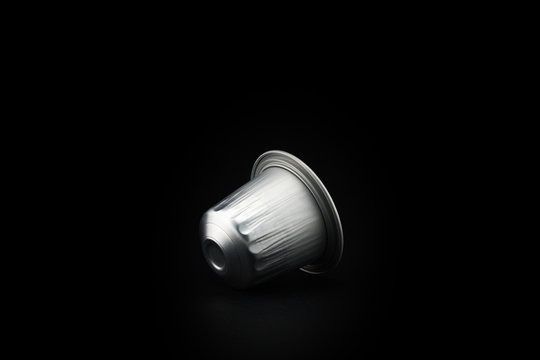 Espresso coffee capsule or coffee pod on black background. Isolated.
