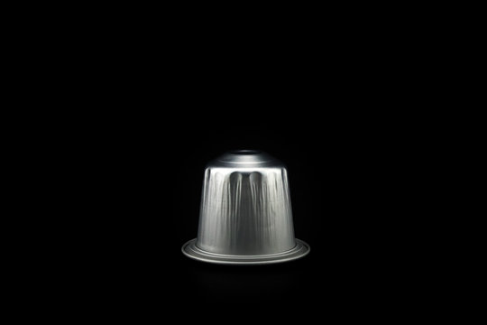 Espresso coffee capsule or coffee pod on black background. Isolated.