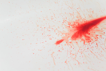 Splashes of blood dripping into the sink in the bathroom.