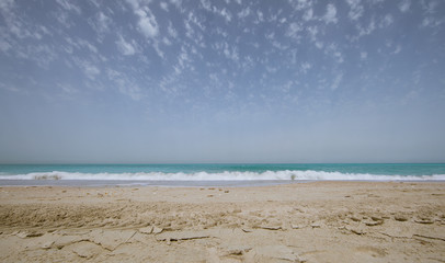 Fototapeta na wymiar panoramic photo of beach sand, blue sea and blue sky