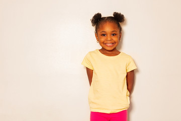 Portrait of nice little black girl smile over wall - Powered by Adobe
