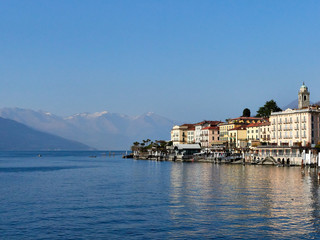 Obraz premium Bellagio, Italy March 30 2019 View of Bellagio town from Lake Como with the mountains as background with some snow in early spring