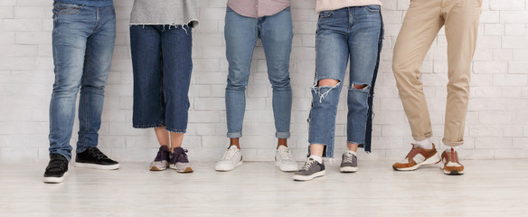 Legs of friends. Young people in jeans and trousers