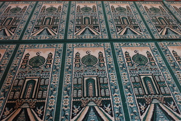 green prayer mat on the mosque