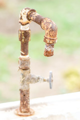 Old rusty water tap in the garden. Macro shot