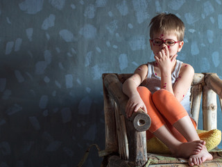 Upset blond child in pink glasses with red ball has chicken pox. Mother smeared follicles with...
