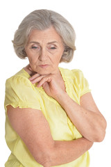 Portrait of sad senior woman posing on white background