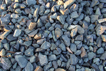 mound of small and large crushed stones with golden light rays