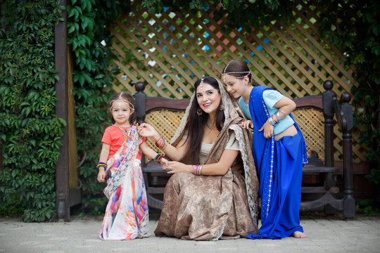 Small children and their mother in traditional Indian attire.