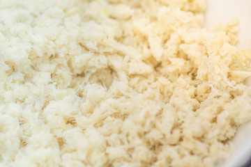 Grated horseradish root background close-up. Macro shot