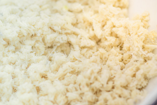 Grated horseradish root background close-up. Macro shot