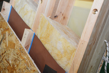 Attic roof construction with damp proof, waterproof and mineral wool insulation layers.