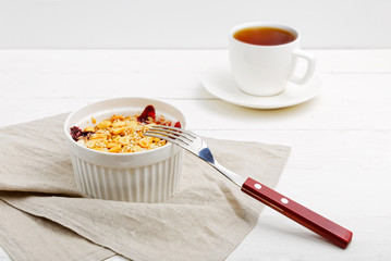 Crumbles with blackberries, peanuts and sesame and cup of tea