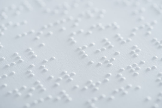 close up view of text in braille code on white paper