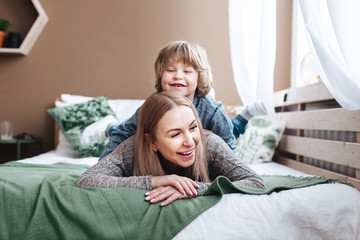 Mom and little son playful at home