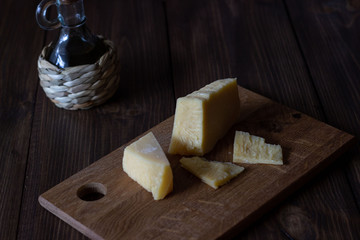 Parmesan and olive oil on a wooden board.