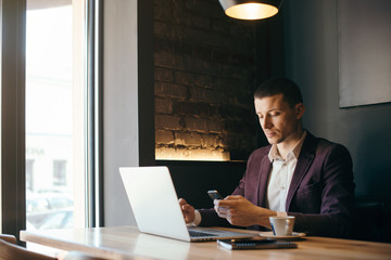Young handsome businessman conducting negotiations with investors. Electronic business. Alternative...