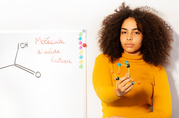 young woman in chemistry class show acid molecule