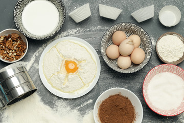 Creating a recipe, Top view of the basic baking ingredients and kitchen utensils on the dark background, cooking concept