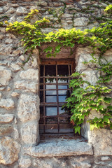 Fototapeta na wymiar Window in a wall of a medieval house in the French village of Eze