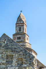 Fototapeta na wymiar Tower of medieval stone church in Densus, Hunedoara, Transylvania, Romania, East Europe. Proposed for UNESCO World Heritage. 