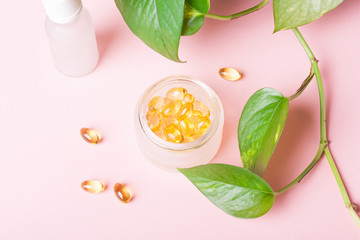 Fish oil capsules (omega-3) on a pink background
