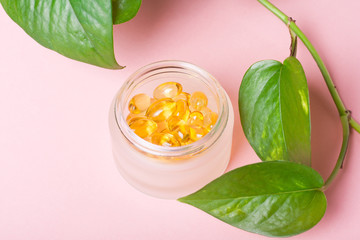 Fish oil capsules (omega-3) on a pink background