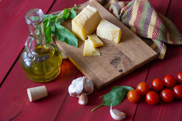 Ingredients for Italian and Mediterranean cuisine. Red wooden background.
