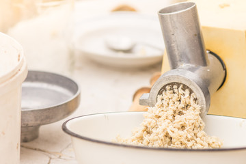 The process of making mashed horseradish root.