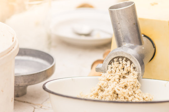 The process of making mashed horseradish root.