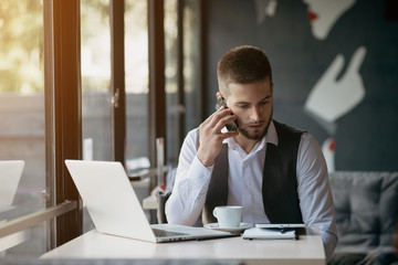 Young man drawing template for the web site associated with digital marketing, current trends and tendencies of UX / UI design. Businessman who rules his company remotely, like a freelancer