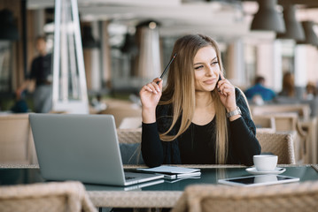 Beautiful girl working out a plan of the project and concept. Girl paints a website design on a...