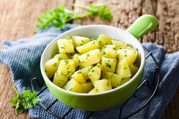 Fresh homemade boiled potatoes with parsley in bowl (Selective Focus, Focus in the middle of the...