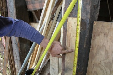 Closeup of Older Man's Hand using measuring tape