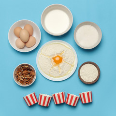 Creating a recipe, Top view of the basic baking ingredients on the blue table, cooking concept