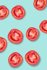 Fresh red tomatoes lay on a blue background.