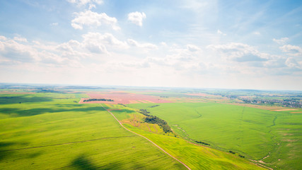 Fototapeta premium the green field is at sunset shot with the drone