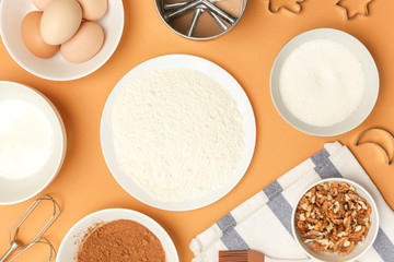 Creating a recipe, Top view of the basic baking ingredients on the orange table, cooking conceptCreating a recipe, Top view of the basic baking ingredients on the orange table, cooking concept