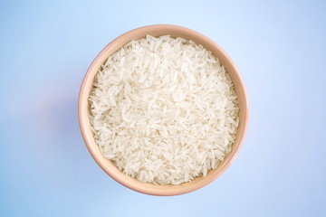 long crumbly steamed rice in a deep beige plate on a gentle blue background