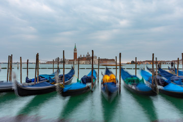Gondolas moored in Piazza San Marco with San Giorgio Maggiore church in the background, Italy